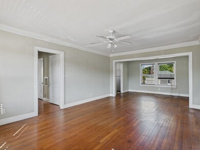 Living & Dining Areas with Crown Molding & Original Hardwood Floors