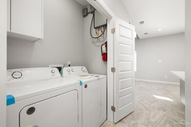 Washroom featuring visible vents, baseboards, independent washer and dryer, cabinet space, and marble finish floor