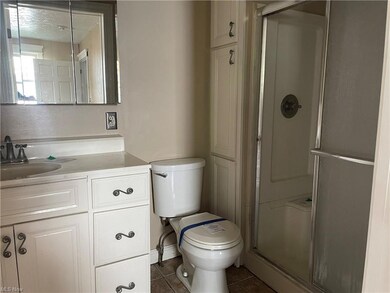 Bathroom featuring mirror, dark tile floors, an en