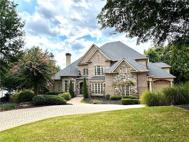 View of front of home with a garage and a front la