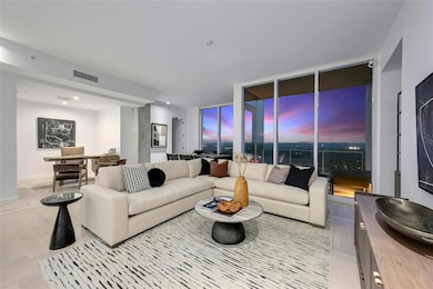 Living room with expansive windows, visible vents