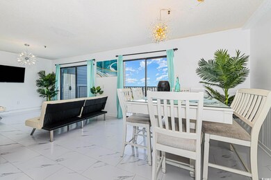 Dining space with a chandelier and marble finish flooring