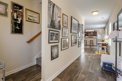 Hallway featuring stairway and dark wood-type flooring