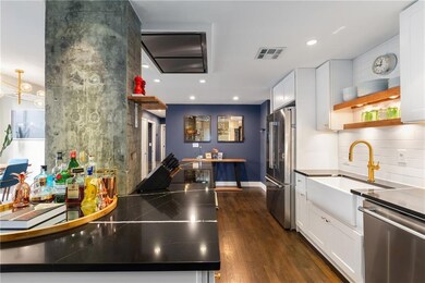 Kitchen featuring stainless steel appliances, white cabinets, dark wood-type flooring, open shelves, and recessed lighting