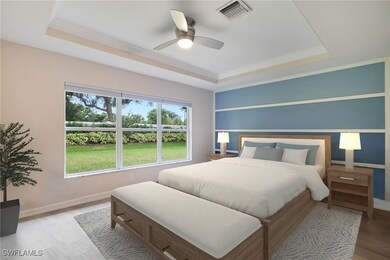 Bedroom featuring a tray ceiling, ceiling fan, and