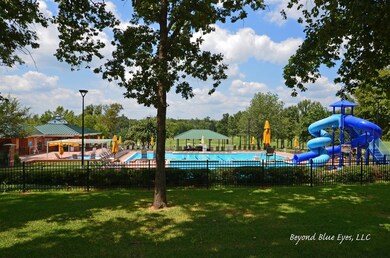 View of swimming pool with a playground, a gazebo,
