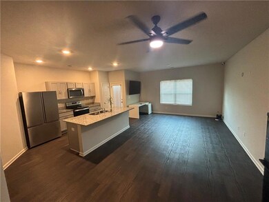 Kitchen with stainless steel appliances, dark wood