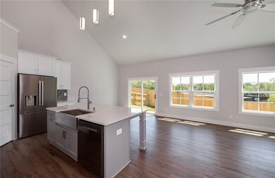 Kitchen featuring open floor plan, stainless steel