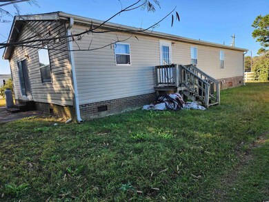 Back of property featuring a lawn