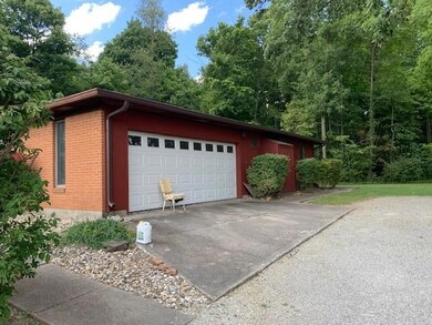 attached garage, finished with paneling and is 22x23