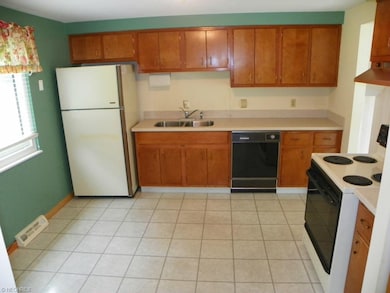 Large eat in kitchen with Corian countertops.
