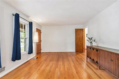 Spare room with light wood finished floors and baseboards