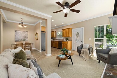 Living room featuring a chandelier, crown molding, ceiling fan, recessed lighting, and light tile patterned floors