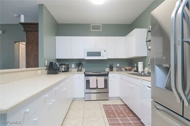 Kitchen featuring light tile patterned floors, whi