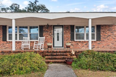 View of exterior entry featuring covered porch