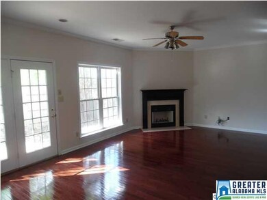 Great room with gleaming wood floors, wood-burning
