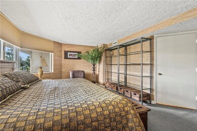 Bedroom with carpet and a textured ceiling