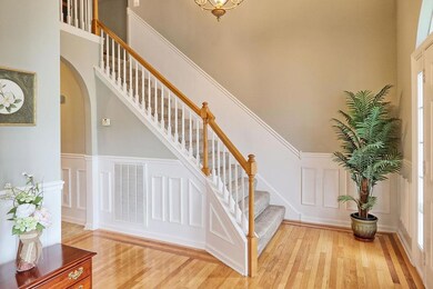 Beautiful staircase to second floor features wainscotting.