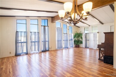 Unfurnished living room featuring vaulted ceiling