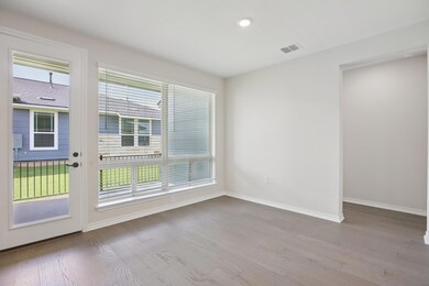 Empty room featuring light wood-style flooring and recessed lighting