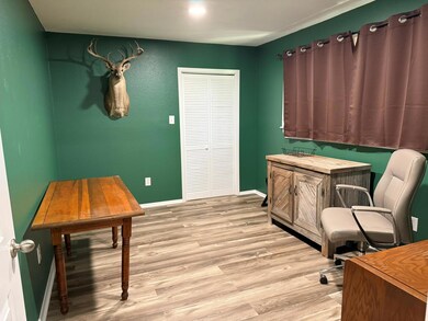 Office space with light wood-style floors and bas