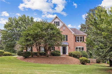 View of front facade with brick siding and a front yard