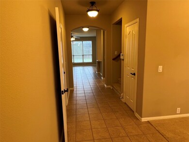 Corridor featuring tile floors