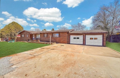 Ranch-style home with a garage, concrete driveway,