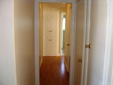 Hallway to bedrooms features laminated wood floori