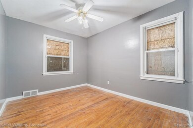 Empty room with light wood-style flooring and a ceiling fan