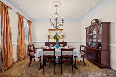 Dining space with a notable chandelier and crown m