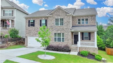 View of front of home featuring a porch, brick siding, driveway, an attached garage, and a shingled roof