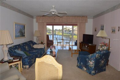Living room with sliders to lanai and view of lake