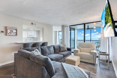 Living room featuring dark wood-type flooring and a wall of windows