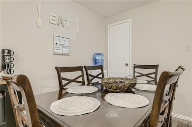 Dining area featuring wood finished floors and ba