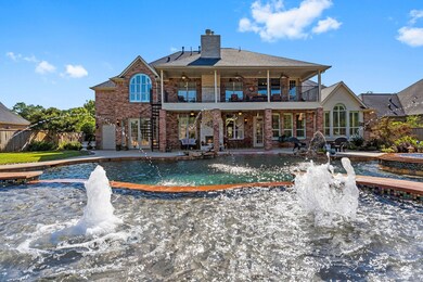 Peering to the rear of the home from the raised deck you see the Jets in the vast Sunshelf across the Pool to upstairs and downstairs Covered decks with fireplace, an array of immense windows, French doors leading to the Sunroom and convenient rear access to the 2nd Garage!