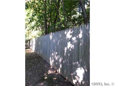 Backyard. Privacy fence in backyard.  Property ext