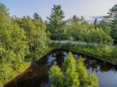 View of 44 Stone Drive with pond and...