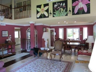 Formal living room with travertine tiled floors, custom paint and triple crown molding