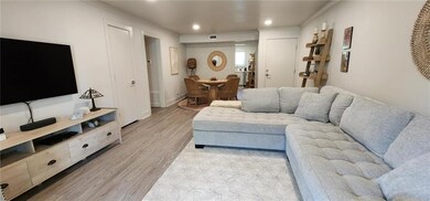 Living room featuring light wood-style flooring, c