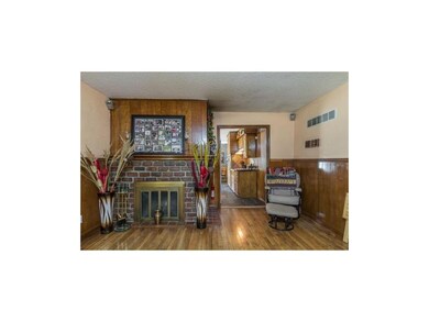 Family Room with hardwood flooring & fireplace.