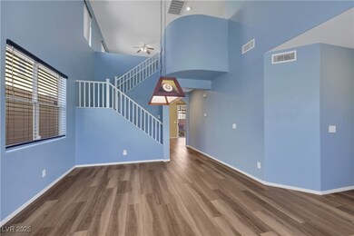 Unfurnished living room with stairs, a towering ce