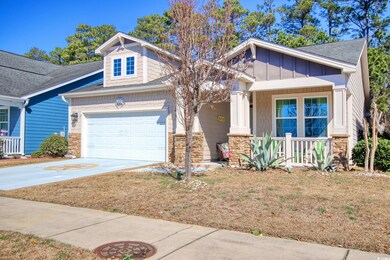 Craftsman-style house with stone siding, a porch, 