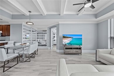 Living room with ceiling fan, ornamental molding, beamed ceiling, and light wood-type flooring