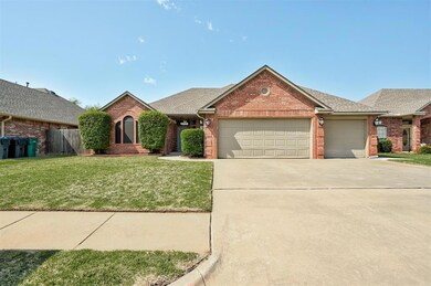 Single story home with a garage and a front yard