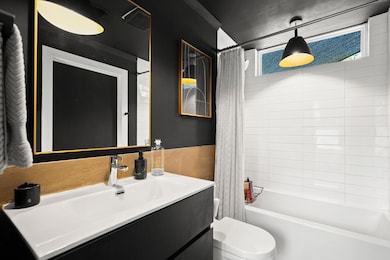Full bath featuring vanity, shower / bath combo w