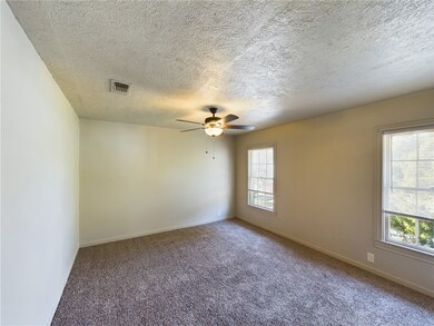 Carpeted spare room featuring plenty of natural li