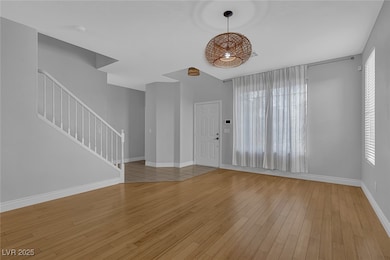 Foyer with stairs and wood finished floors