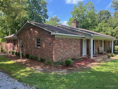 The driveway on the left side of the house with a