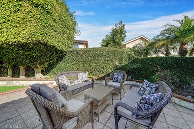 Welcoming Front Courtyard Entry with Patios and Lawn Area